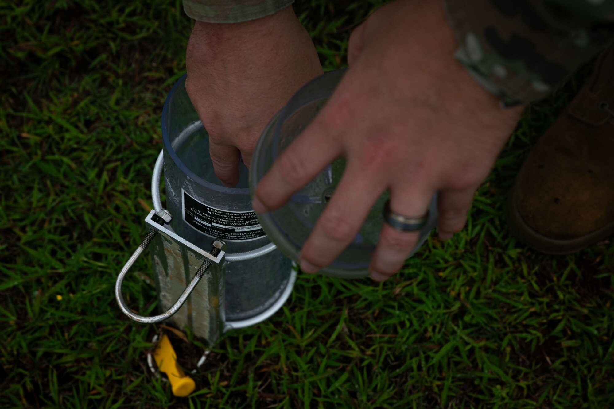 Photo of an Airman securing a rain gauge