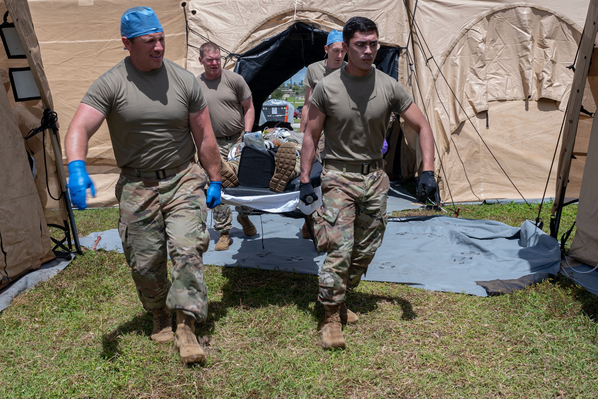 Photo of Airmen transporting a simulated patient