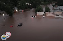 Cars underwater in a neighborhood.