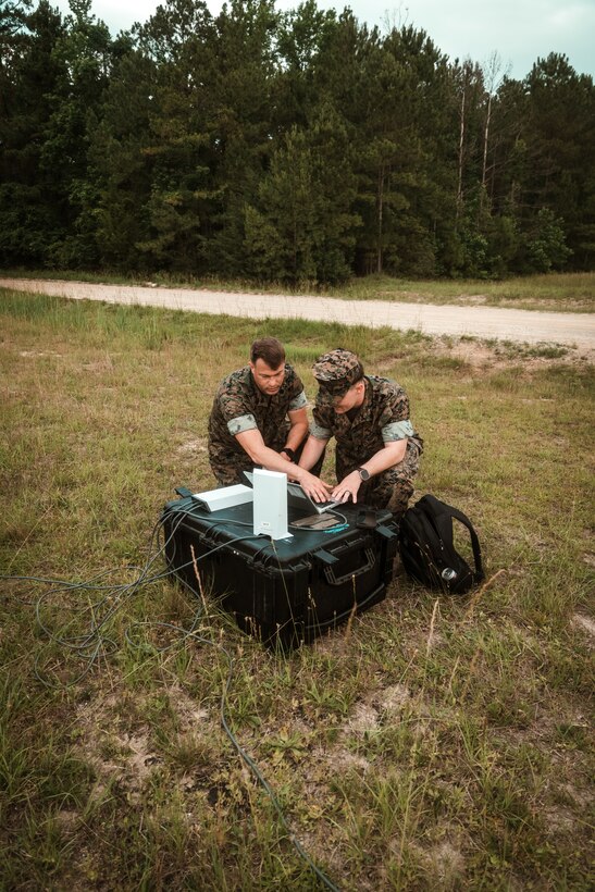 Staff Sgt. Dunn, a representative for Tactical Communications and Electromagnetic Warfare Systems (TCE), and Master Sgt. Daniel Brown, II Marine Expeditionary Force Communications Strategy and Operations, conduct setup and alignment of a Star Shield antenna during an Expeditionary Field Training Exercise at Camp Lejeune, N.C.