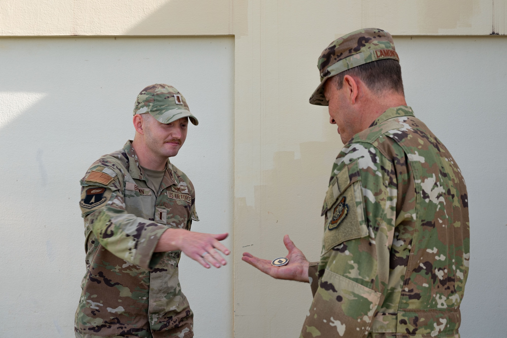Photo of the Air Mobility Command commander coining an Airman