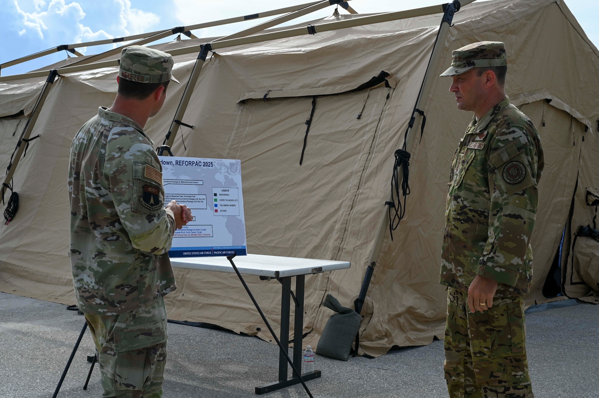 Photo of an Airman briefing the Air Mobility Command commander