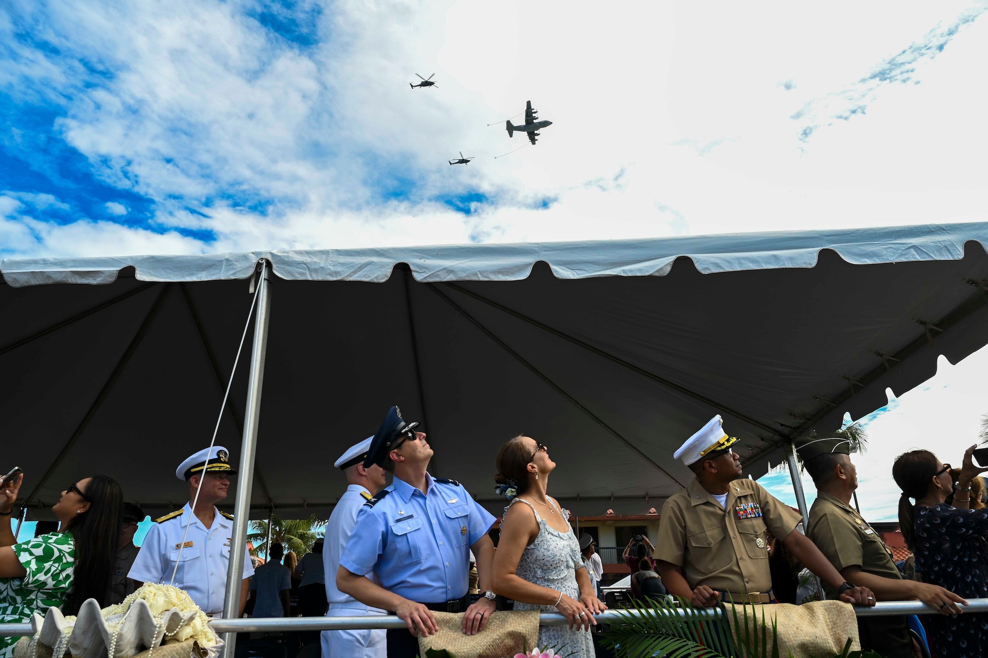 Photo of leadership watching aircraft fly over a parade
