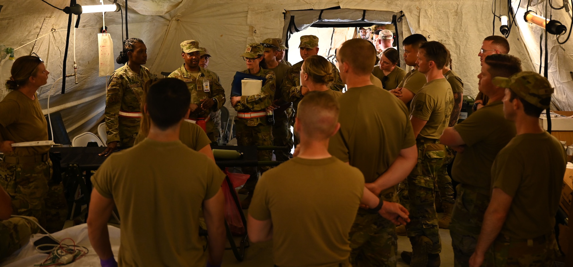 U.S. Air Force observer controller trainers provide feedback to the 673rd Medical Expeditionary Support participants after a stress inoculation scenario during exercise Resolute Force Pacific 2025 at Andersen Air Force Base, Guam, July 16, 2025. (U.S. Air Force photo by Airman 1st Class Adasha Williams)