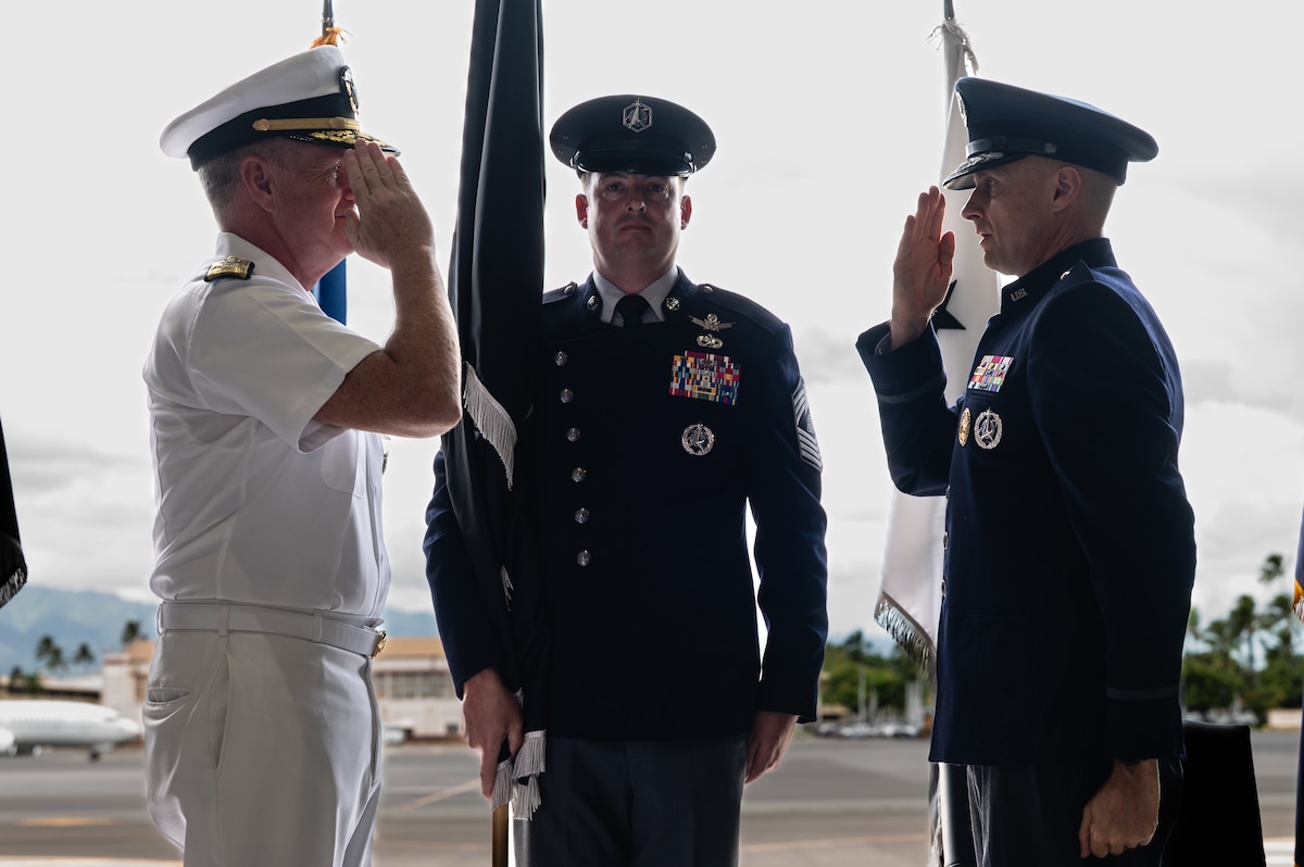 Two men salute one another