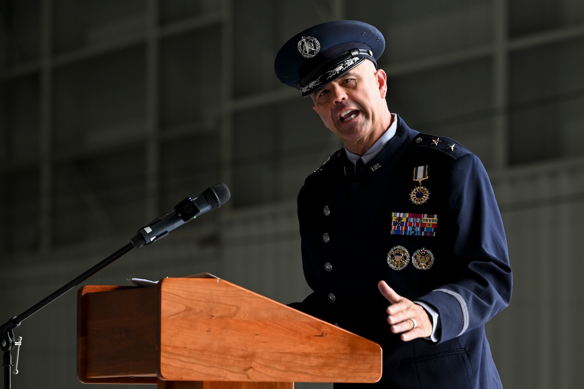 A man in uniform speaks behind a podium