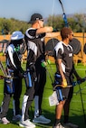 U.S. Army Staff Sgt. Coty Tuck, center, nocks an arrow in his bow and takes aim at his target during the archery event at the 2025 Department of Defense Warrior Games, Colorado Springs, Colorado, July 25, 2025.