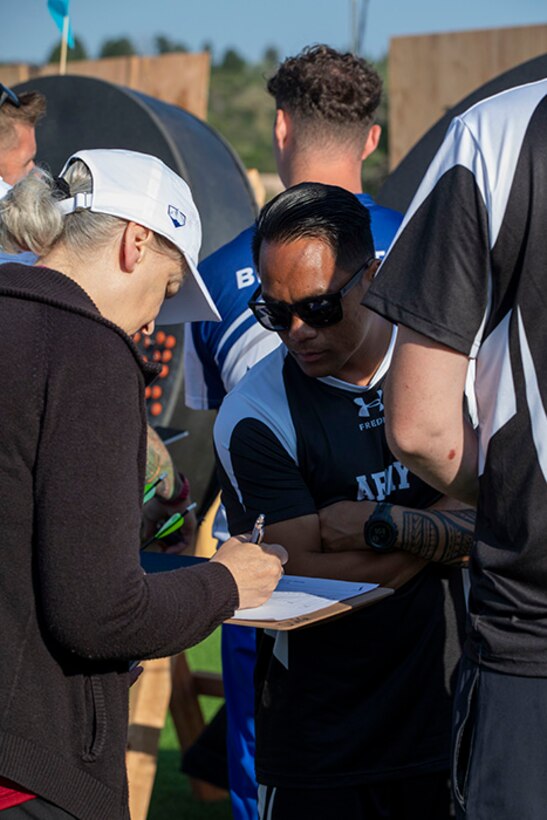 U.S. Army Staff Sgt. Nathaniel Mateo reviews paperwork with an official during the archery event at the 2025 Department of Defense Warrior Games in Colorado Springs, Colorado, July 25, 2025.
