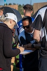 U.S. Army Staff Sgt. Nathaniel Mateo reviews paperwork with an official during the archery event at the 2025 Department of Defense Warrior Games in Colorado Springs, Colorado, July 25, 2025.