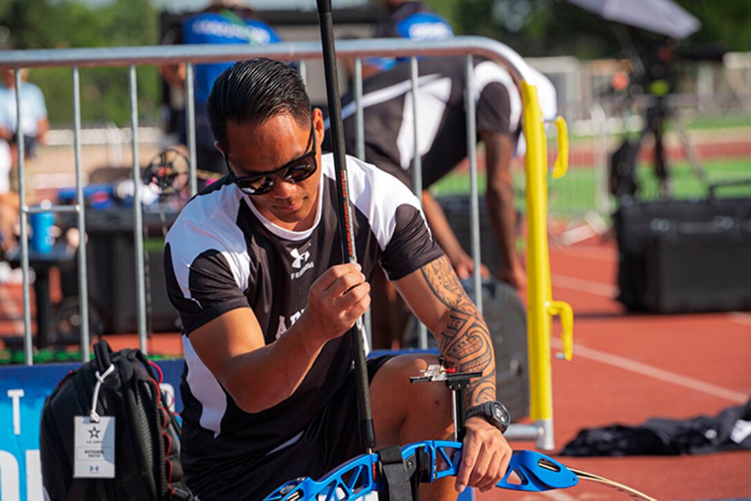U.S. Army Staff Sgt. Nathaniel Mateo disassembles his recurve bow at the archery event during the 2025 Department of Defense Warrior Games at Washburn Field in Colorado Springs, Colorado, July 25, 2025