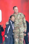 U.S. Army Capt. Kyra Maggio, left, is presented two gold medals for the cycling event by the Deputy Commanding General for Operations, U.S. Army Space and Missile Defense Command Brig. Gen. Donald K. Brooks.