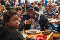 U.S. Army Staff Sgt. Derrick Thompson poses with his son while attending a Western themed Family Day during the 2025 Department of Defense Warrior Games in Colorado Springs, Colorado, July 24, 2025.