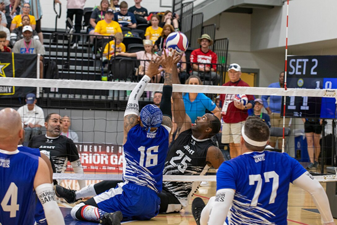 U.S. Army Staff Sgt. Derrick Thompson, Team Army, attempts to block the ball during a sitting volleyball match with Team Air Force at the 2025 Department of Defense Warrior Games, Colorado Springs, Colorado, July 25, 2025.