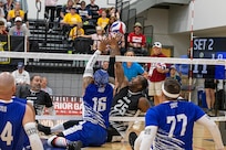 U.S. Army Staff Sgt. Derrick Thompson, Team Army, attempts to block the ball during a sitting volleyball match with Team Air Force at the 2025 Department of Defense Warrior Games, Colorado Springs, Colorado, July 25, 2025.