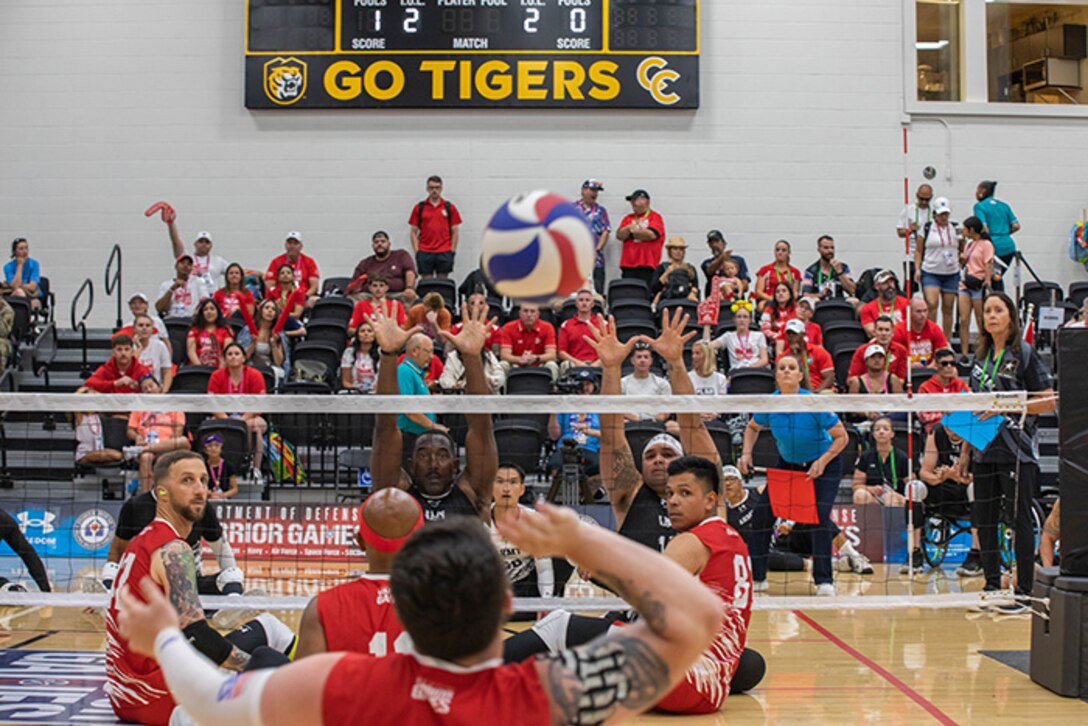 Team Marine Corps serves the ball to Team Army during a sitting volleyball match at the 2025 Department of Defense Warrior Games, Colorado Springs, Colorado, July 25, 2025.