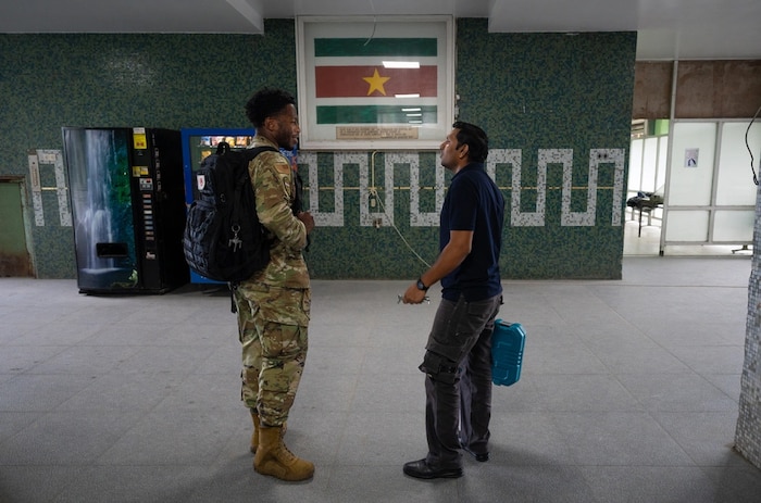 Image of Senior Airman Adrese Atkins, 931st Aerospace Medical Squadron medical administration technician, left, meets Kiran Oedai, biomedical technician, at Academic Hospital Paramaribo, Suriname, July 17, 2025. Atkins, who previously served as an active duty aircraft metals technology specialist, said his maintenance background contributes to his creative problem solving when repairing inoperable equipment and devices in an austere environment. (U.S. Air Force photo by Tech. Sgt. Elora J. McCutcheon)