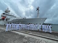 Indian Navy and Indian Coast Guard personnel alongside U.S. Navy sailors pose for a photo in front of the pathfinder class oceanographic survey ship USNS Bowditch (T-AGS 62) during a scheduled port visit to Sri Vijaya Puram, India, July 25, 2025.