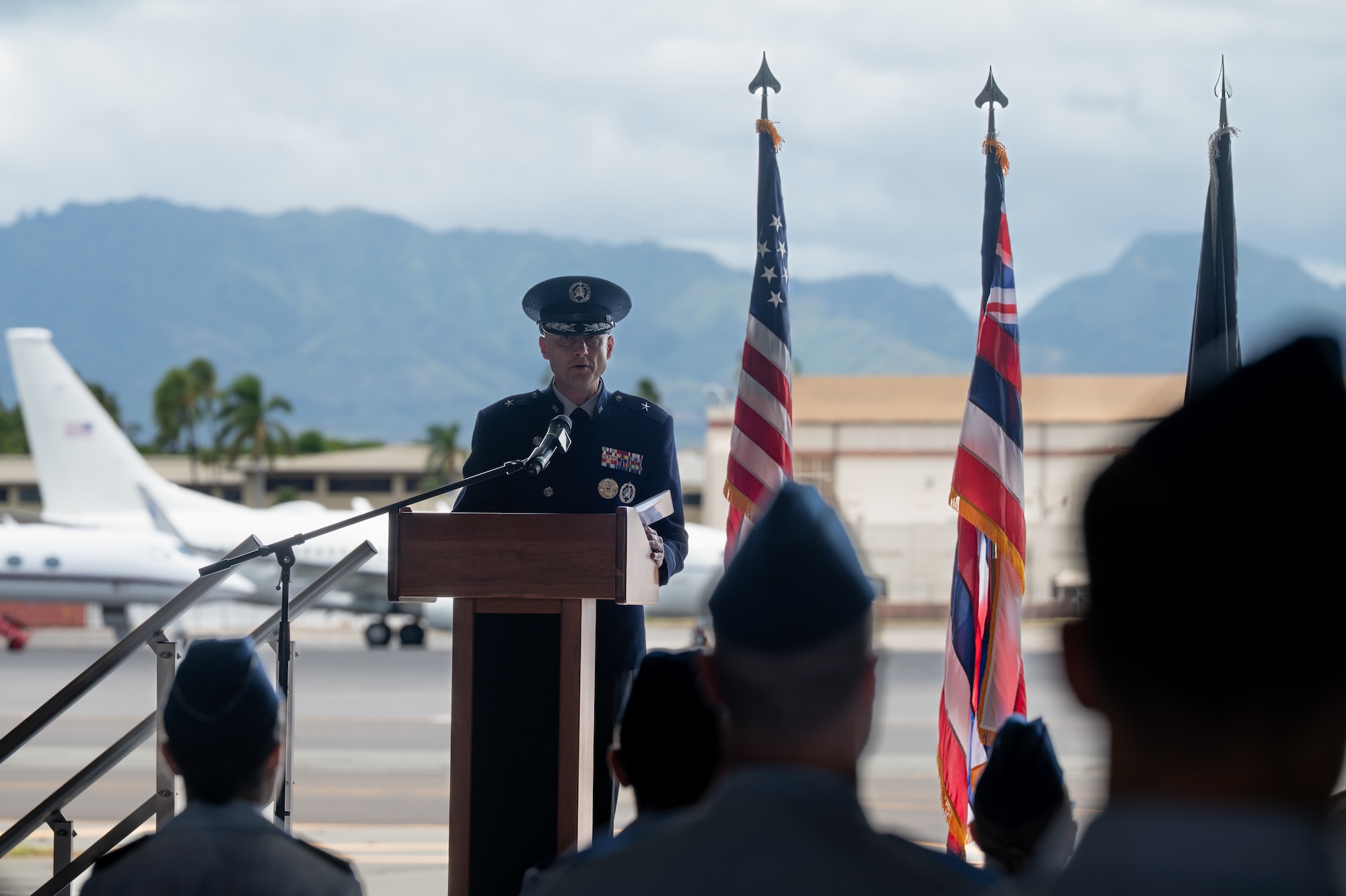 A man in uniform speaks at a podium