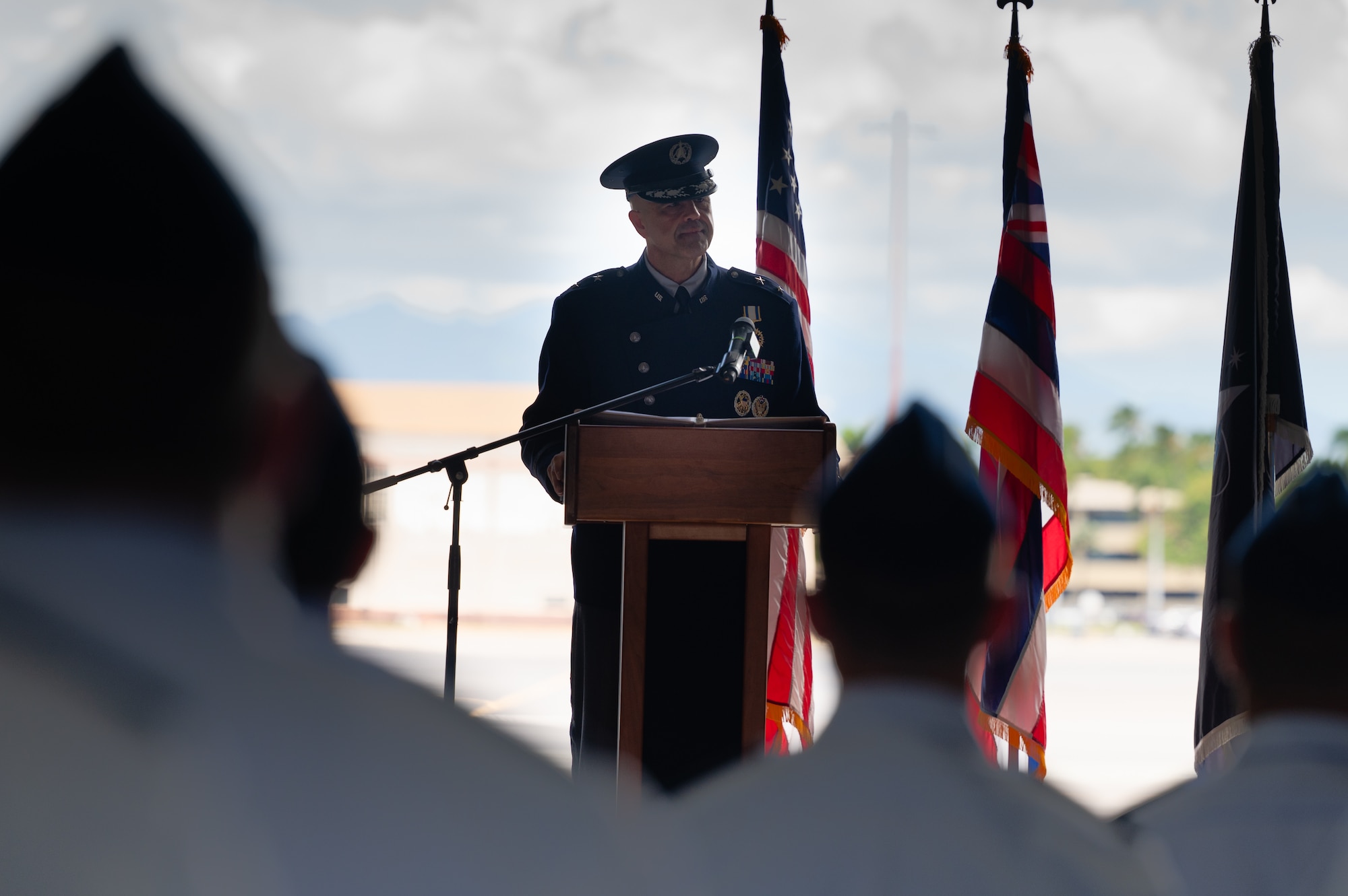 A man in uniform speaks at a podium
