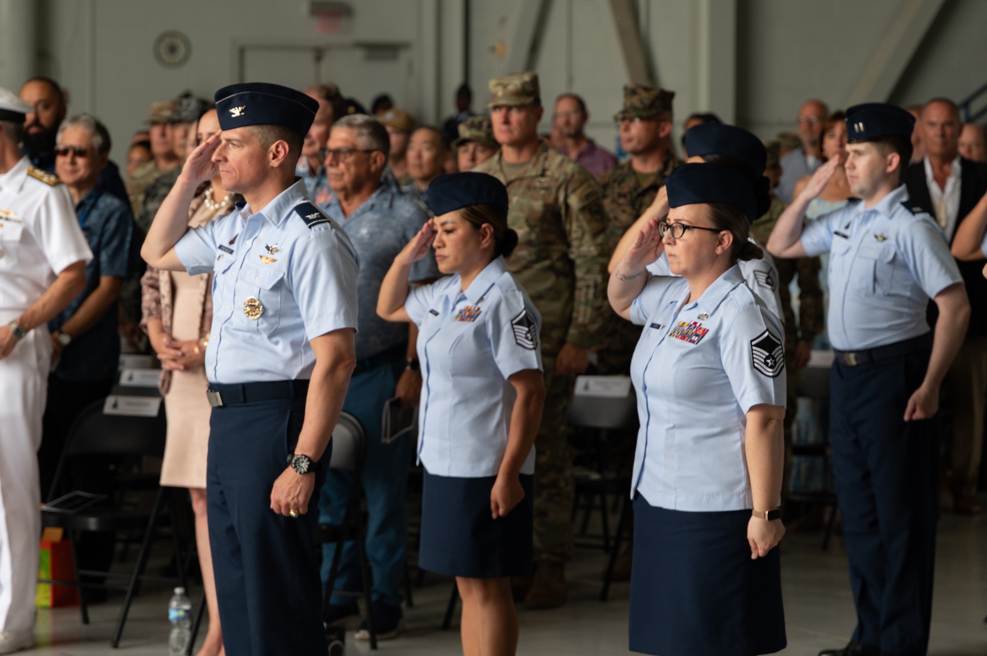 A group of men and women in uniform salute