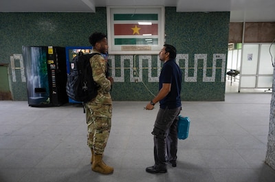 Image of Senior Airman Adrese Atkins, 931st Aerospace Medical Squadron medical administration technician, left, meets Kiran Oedai, biomedical technician, at Academic Hospital Paramaribo, Suriname, July 17, 2025. Atkins, who previously served as an active duty aircraft metals technology specialist, said his maintenance background contributes to his creative problem solving when repairing inoperable equipment and devices in an austere environment. (U.S. Air Force photo by Tech. Sgt. Elora J. McCutcheon)