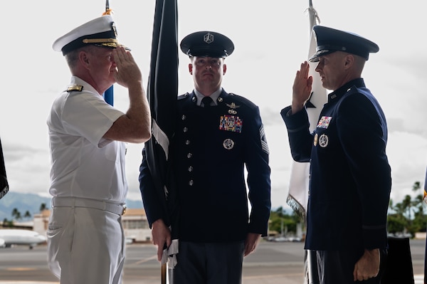 Two men salute one another