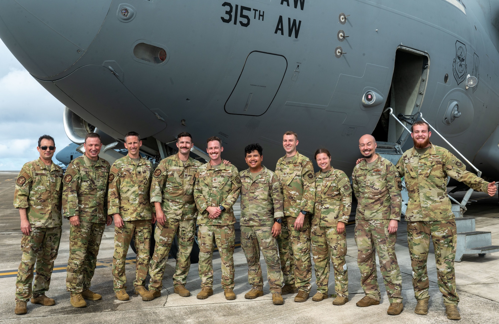 U.S. Air Force Gen. Johnny Lamontagne, commander of Air Mobility Command, poses for a group photo with C-17 crew members after arriving at Andersen Air Force Base, Guam.