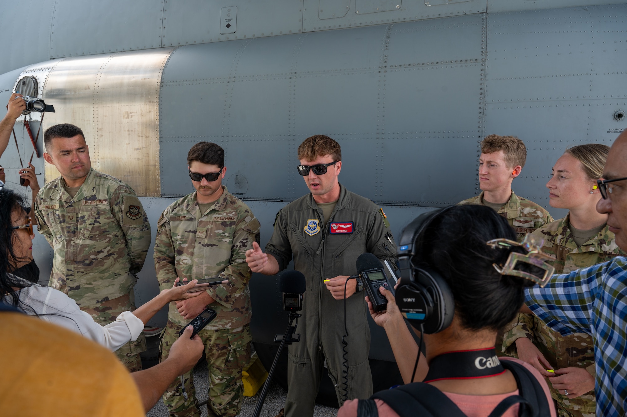 U.S. Air Force Airmen assigned to 39th Airlift Squadron, Dyess Air Force Base, Texas, answer questions from local media about the Department-Level Exercise series at Andersen Air Force Base, Guam.