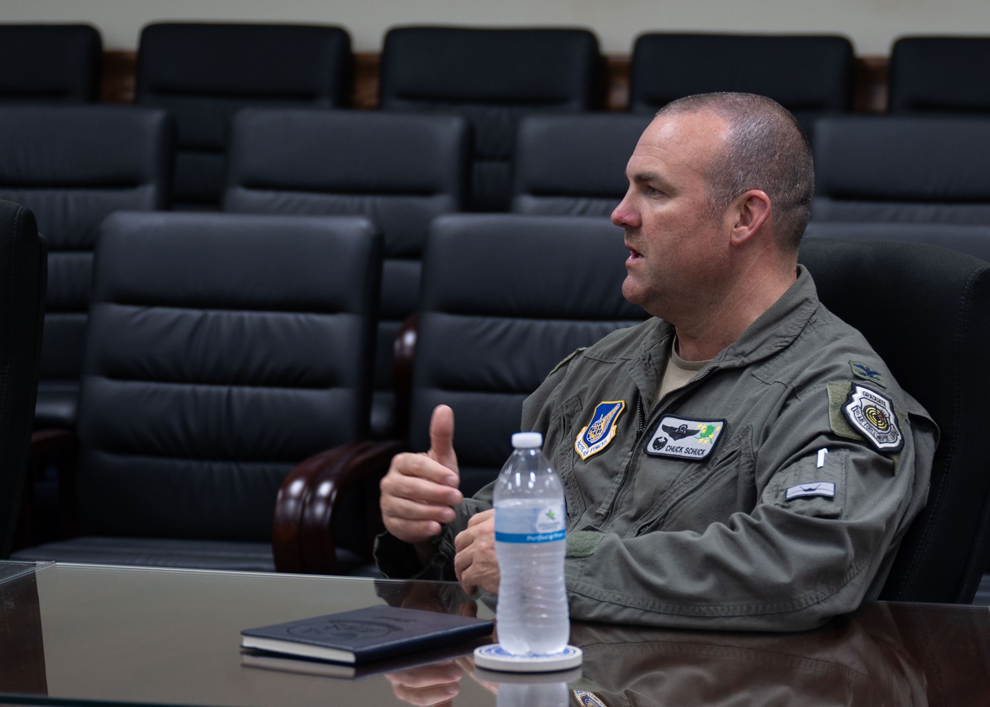 U.S. Air Force Col. Charles Schuck, 3rd Air Expeditionary Wing commander, answers questions from local reporters about the Department-Level Exercise series during a roundtable talk at Andersen Air Force Base, Guam.
