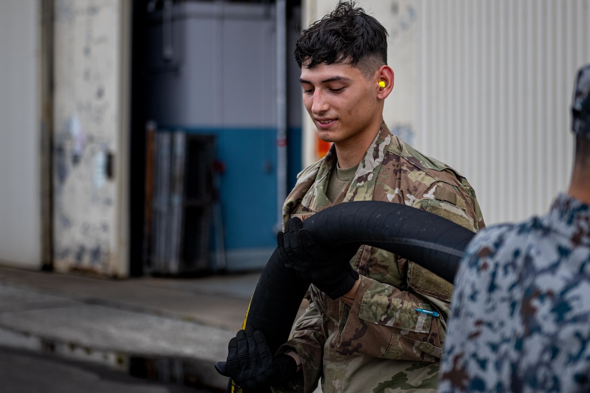 U.S. Air Force Airman 1st Class Andrew Mikel, 35th Logistic Readiness Squadron fuels distribution operator, pulls a fuel hose before fueling a U.S. Air Force HH-60 Pave Hawk during exercise Resolute Force Pacific (REFORPAC) 2025.