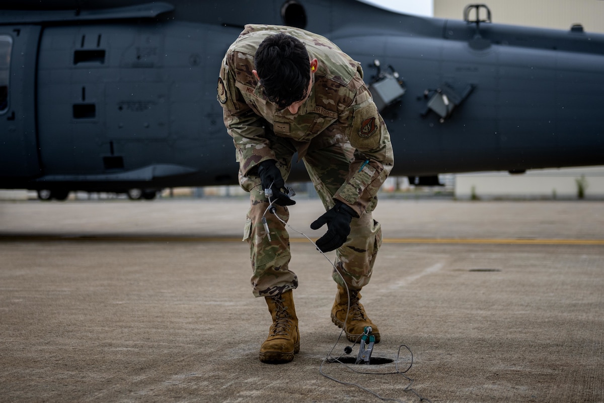 U.S. Air Force Airman 1st Class Andrew Mikel, 35th Logistic Readiness Squadron fuels distribution operator, grounds a U.S. Air Force HH-60W Jolly Green II before refueling during exercise Resolute Force Pacific (REFORPAC) 2025.