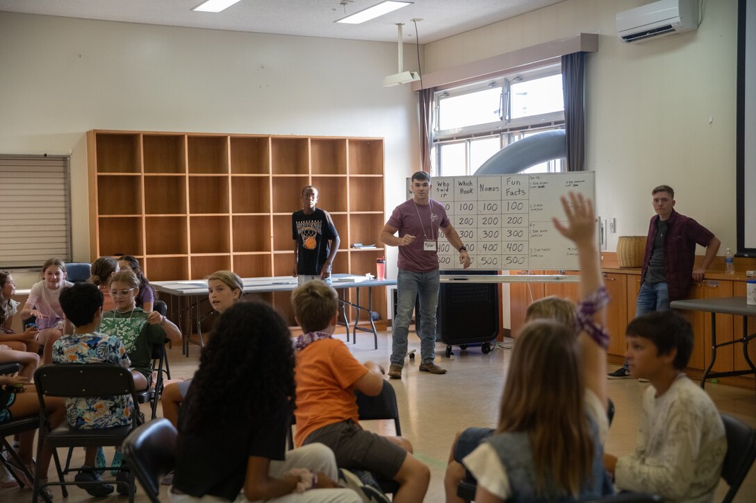 U.S. Marine Corps 2nd Lt. Tyler Walker, supply officer, Headquarters and Headquarters Squadron, Marine Corps Air Station Iwakuni, hosts a Bible trivia game during a Vacation Bible School at MCAS Iwakuni, Japan, July 15, 2025. The MCAS Iwakuni chapel’s 3-day Vacation Bible School taught children from the installation about the Bible through various interactive activities. (U.S. Marine Corps photo by Cpl. Colin Thibault)