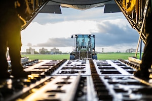 A forklift waiting outside the ramp of an aircraft