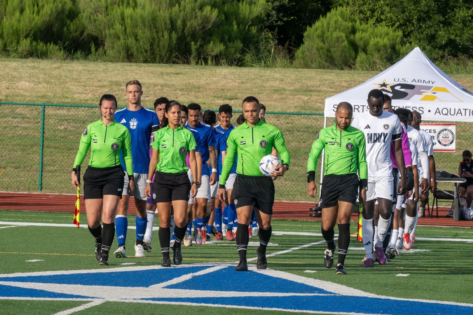 FORT HOOD, TEXAS (July 27, 2025) Officials escort the U.S. Air Force and U.S. Navy Men’s Soccer teams onto the field before the game during the Armed Forces Men’s Soccer Championship, July, 27, 2025 at Phantom Warrior Stadium, Fort Hood Texas. Military service teams, Army, Navy, and Air Force compete in a bracket tournament for the championship title. Armed Forces Sports fosters goodwill by promoting physical fitness, providing competitive opportunities for military athletes at national and international levels, enhancing recruitment and retention through sports diplomacy, and building strategic partnerships with allied nations. (U.S. Department of Defense photo by Mass Communication Specialist 2nd Class Theodore C. Lee)
