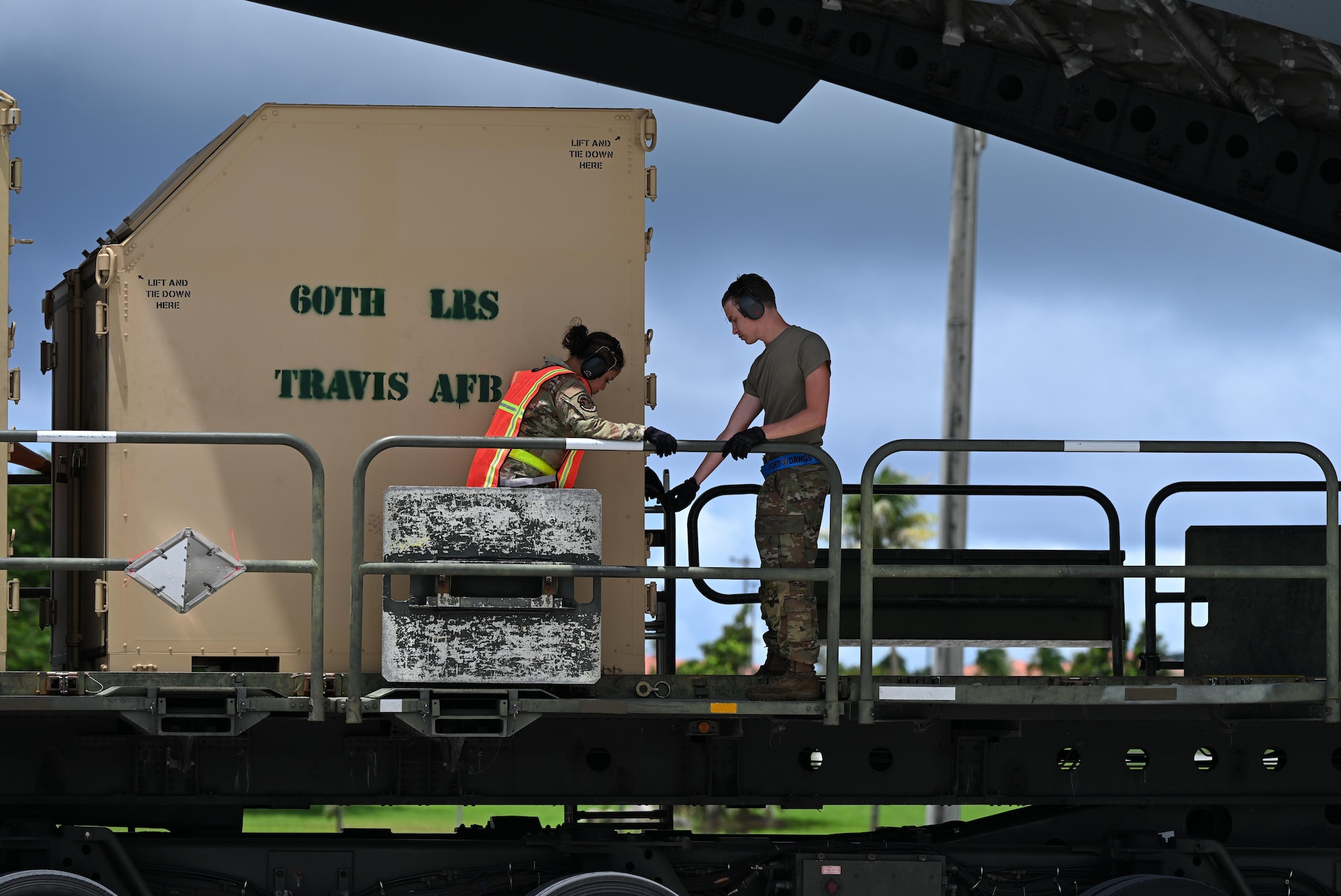 Pallets are rapidly offloaded from a U.S. Air Force C-17 Globemaster III assigned to the 21st Airlift Squadron, Travis Air Force Base, Calif., during engine running offload training at Andersen Air Force Base, Guam, July 10, 2025. The training tested agile logistics support and contingency mobility, contributing to exercise Resolute Force Pacific. The REFORPAC exercise is part of the first-in-a-generation Department-Level Exercise series, a new way of conducting operations in a contested, dynamic environment to build capabilities making a stronger, more lethal deterrent force. (U.S. Air Force photo by Senior Airman Audree Campbell)