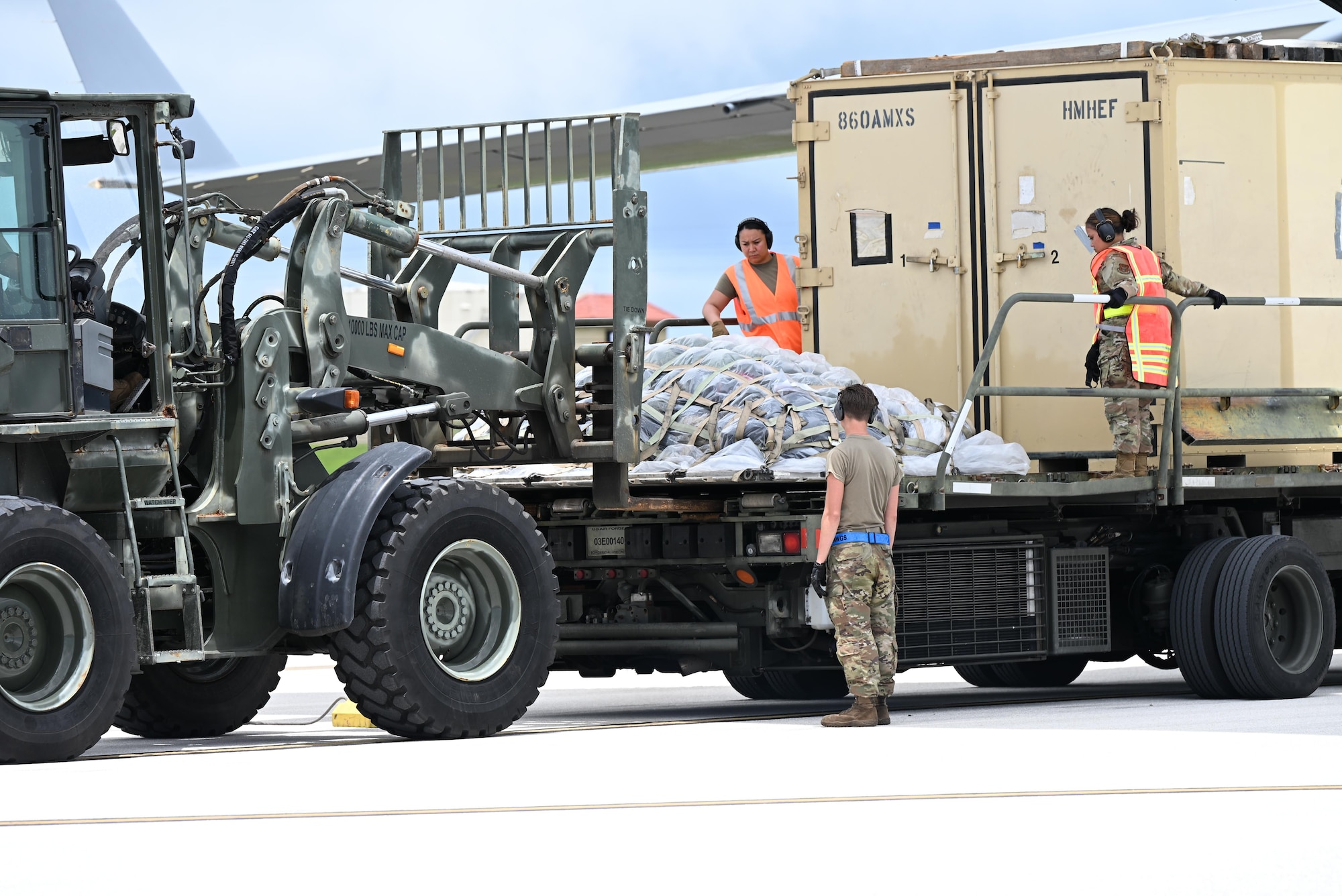 Pallets are rapidly offloaded from a U.S. Air Force C-17 Globemaster III assigned to the 21st Airlift Squadron, Travis Air Force Base, Calif., during engine running offload training at Andersen Air Force Base, Guam, July 10, 2025. The training tested agile logistics support and contingency mobility, contributing to exercise Resolute Force Pacific. The REFORPAC exercise is part of the first-in-a-generation Department-Level Exercise series, a new way of conducting operations in a contested, dynamic environment to build capabilities making a stronger, more lethal deterrent force. (U.S. Air Force photo by Senior Airman Audree Campbell)