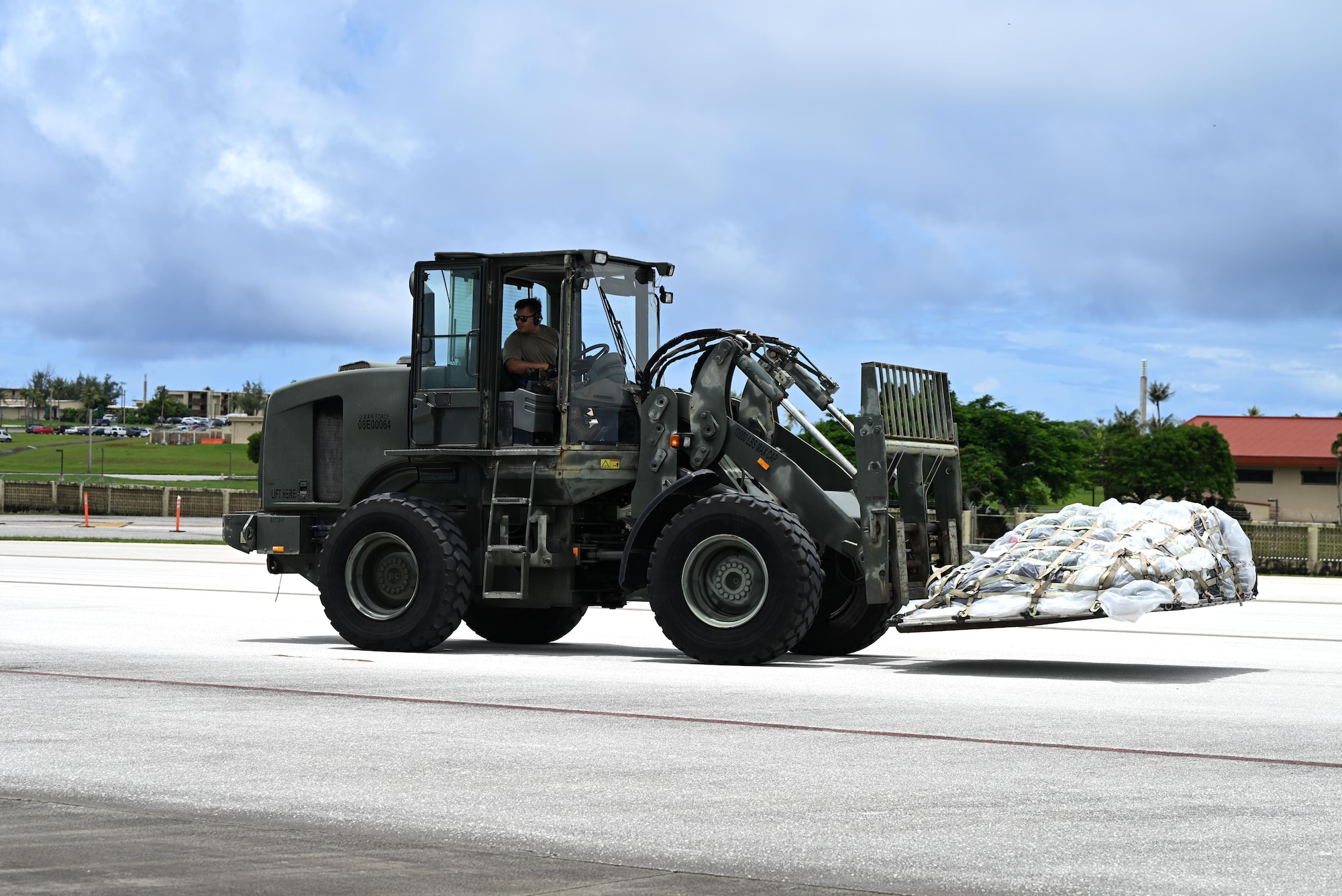 Pallets are rapidly offloaded from a U.S. Air Force C-17 Globemaster III assigned to the 21st Airlift Squadron, Travis Air Force Base, Calif., during engine running offload training at Andersen Air Force Base, Guam, July 10, 2025. The training tested agile logistics support and contingency mobility, contributing to exercise Resolute Force Pacific. The REFORPAC exercise is part of the first-in-a-generation Department-Level Exercise series, a new way of conducting operations in a contested, dynamic environment to build capabilities making a stronger, more lethal deterrent force. (U.S. Air Force photo by Senior Airman Audree Campbell)