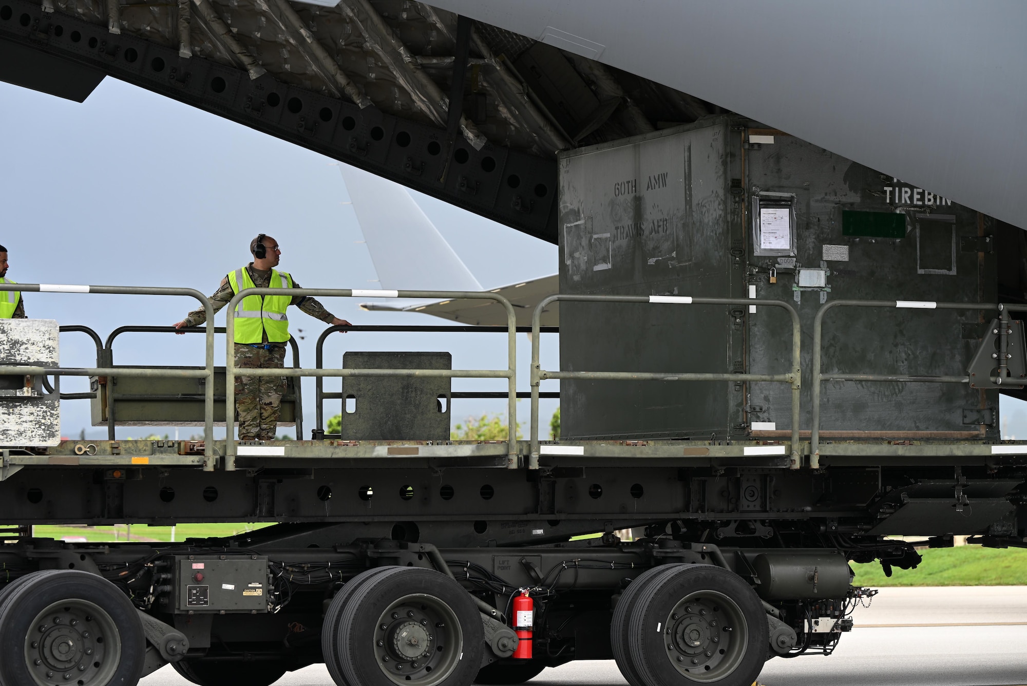 Pallets are rapidly offloaded from a U.S. Air Force C-17 Globemaster III assigned to the 21st Airlift Squadron, Travis Air Force Base, Calif., during engine running offload training at Andersen Air Force Base, Guam, July 10, 2025. The training tested agile logistics support and contingency mobility, contributing to exercise Resolute Force Pacific. The REFORPAC exercise is part of the first-in-a-generation Department-Level Exercise series, a new way of conducting operations in a contested, dynamic environment to build capabilities making a stronger, more lethal deterrent force. (U.S. Air Force photo by Senior Airman Audree Campbell)