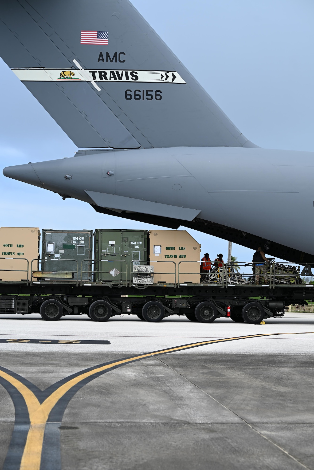 Pallets are rapidly offloaded from a U.S. Air Force C-17 Globemaster III assigned to the 21st Airlift Squadron, Travis Air Force Base, Calif., during engine running offload training at Andersen Air Force Base, Guam, July 10, 2025. The training tested agile logistics support and contingency mobility, contributing to exercise Resolute Force Pacific. The REFORPAC exercise is part of the first-in-a-generation Department-Level Exercise series, a new way of conducting operations in a contested, dynamic environment to build capabilities making a stronger, more lethal deterrent force. (U.S. Air Force photo by Senior Airman Audree Campbell)