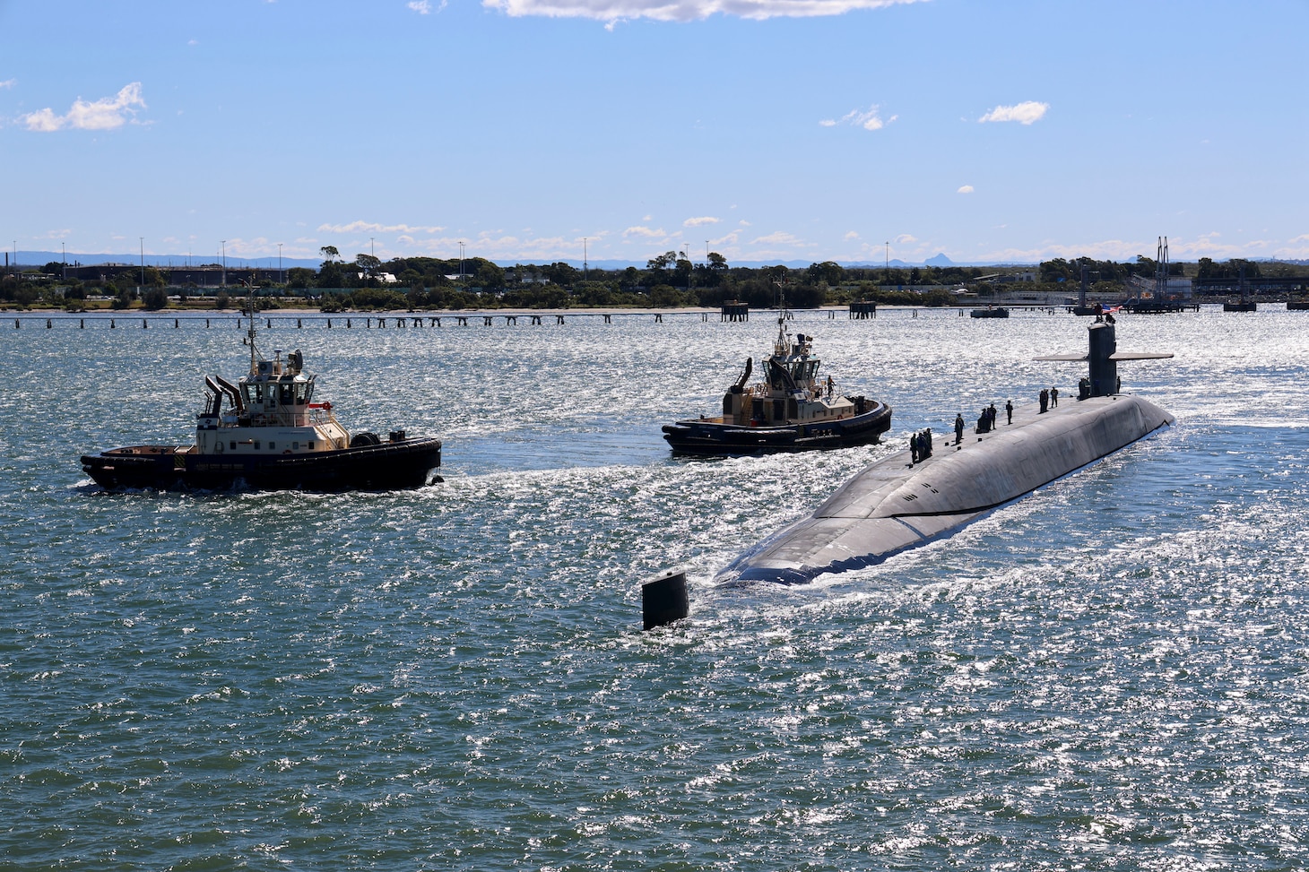 BRISBANE, Australia (July 27, 2025) – The Ohio-class guided-missile submarine USS Ohio (SSGN 726) prepares to moor alongside the forward-deployed submarine tender USS Frank Cable (AS 40) in Brisbane, Australia for a scheduled port visit, July 27, 2025. Ohio and Frank Cable are in port Brisbane, Australia, as part of routine operations in support of the U.S. 7th Fleet, the U.S. Navy’s largest forward-deployed numbered fleet, operating with allies and partners in preserving a free and open Indo-Pacific region. (U.S. Navy photo by Mass Communication Specialist 1st Class Karri Langerman)