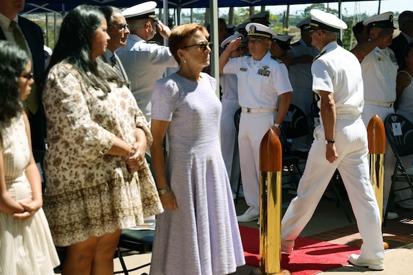 Barbara Valdes stands at attention as she watches her husband Rear Adm. Guido Valdes, the former commander, Naval Medical Forces Pacific (NMFP), departs at the conclusion of a change of command ceremony where he relinquished command to Rear Adm. Kevin Brown. Valdes will transition to his new assignment as The Medical Officer for the Marine Corps and director, U.S. Marine Corps Health Services. (U.S. Navy photo by Arsenio R. Cortez Jr.)