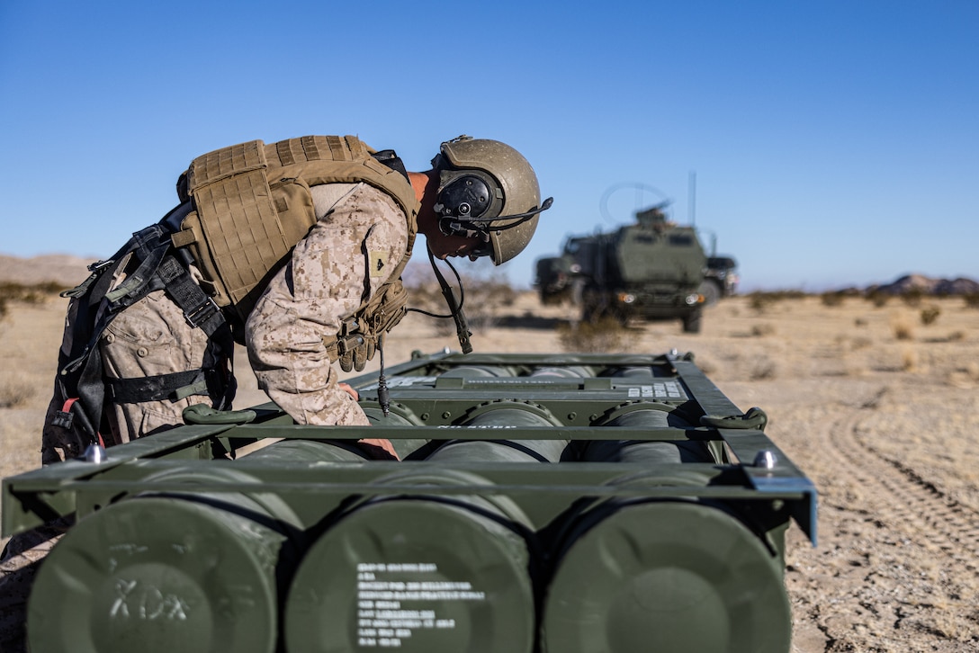 U.S. Marine Corps Cpl. Riley McKamey, a High Mobility Artillery Rocket System operator with 2d Battalion, 10th Marine Regiment, 2d Marine Division, checks rounds for a M142 High Mobility Artillery Rocket System during Service Level Training Exercise 4-25, on Marine Corps Air-Ground Combat Center, Twentynine Palms, California, July 25, 2025. SLTE 4-25 is designed to be a challenging, realistic training environment that produces combat-ready forces capable of operating as an integrated Marine Air Ground Task Force across all domains of military operations. (U.S. Marine Corps photo by Lance Cpl. Judith Ann Lazaro)
