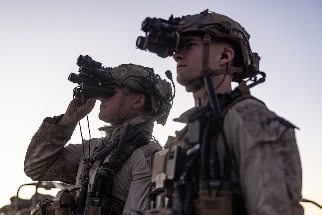 U.S. Marine Corps Cpl. Michael Defrancesco, left, a reconnaissance Marine and Sgt. Jacob Miller, a team leader, both with 2d Reconnaissance Battalion, 2d Marine Division, sight-in through their AN/PVS-31A Binocular Night Vision Goggles during Service Level Training Exercise 4-25, on Marine Corps Air-Ground Combat Center, Twentynine Palms, California, July 24, 2025. SLTE 4-25 is designed to be a challenging, realistic training environment that produces combat-ready forces capable of operating as an integrated Marine Air Ground Task Force across all domains of military operations. (U.S. Marine Corps photo by Lance Cpl. Judith Ann Lazaro)