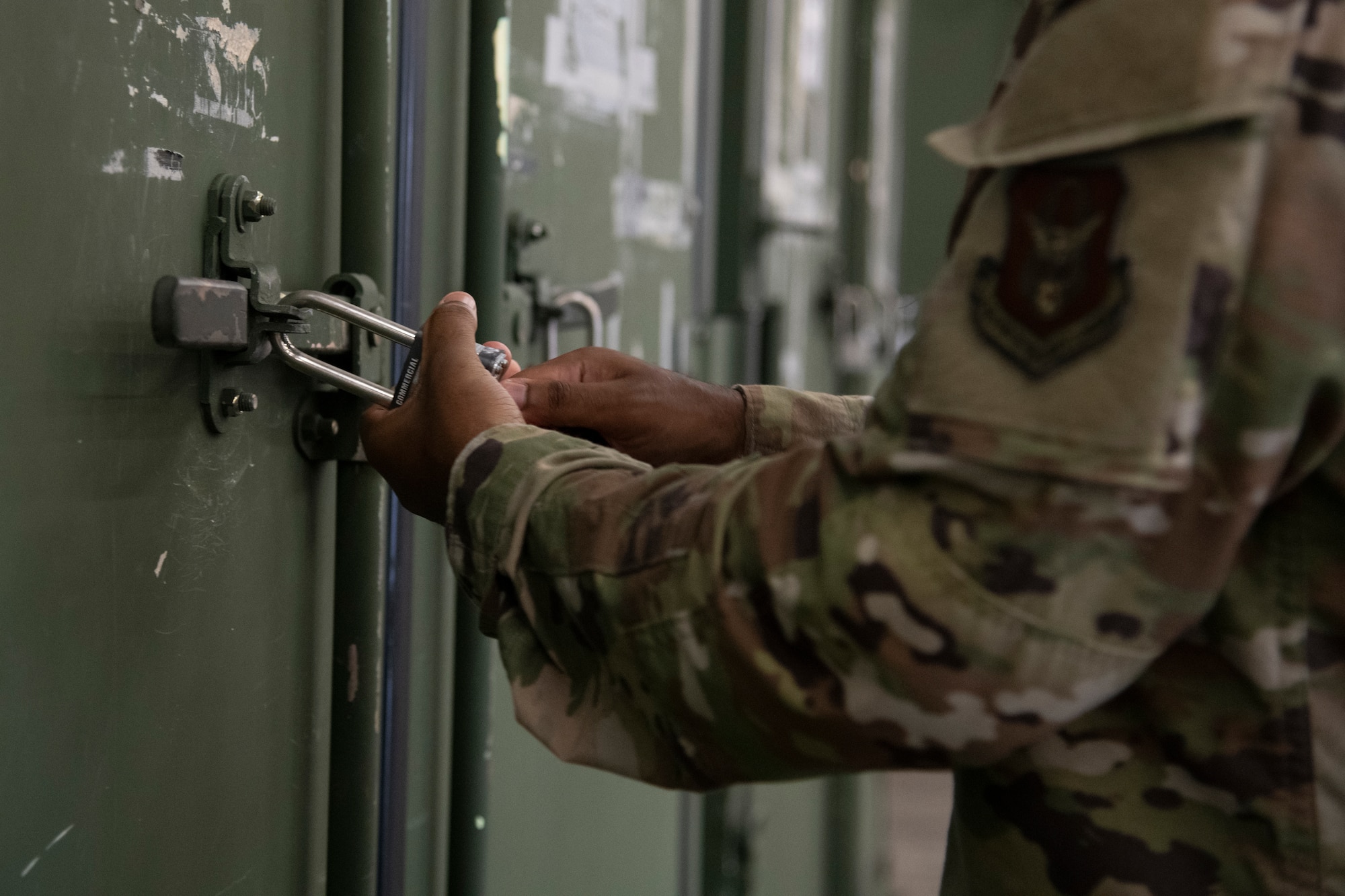 Airman unlocks a storage container.