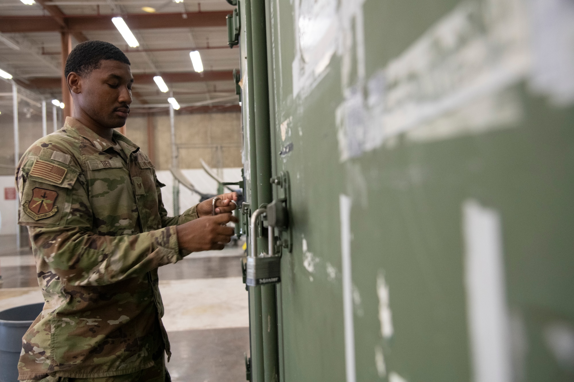 Airman closes a storage container.