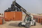 A container handler moves a container in preparation for a large shipment of construction materials to various military installations throughout the USCENTCOM area of responsibility Dec. 14, 2024. DLA Troop Support's Construction and Equipment supply chain supports activities like this through programs utilizing economies of scale to provide heavy equipment, containers and construction materials efficiently and effectively to their customers around the globe. (U.S. Army photo by Joseph Kumzak)