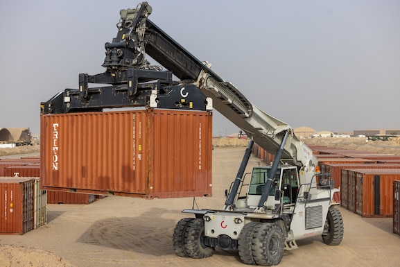A container handler moves a container in preparation for a large shipment of construction materials to various military installations throughout the USCENTCOM area of responsibility Dec. 14, 2024. DLA Troop Support's Construction and Equipment supply chain supports activities like this through programs utilizing economies of scale to provide heavy equipment, containers and construction materials efficiently and effectively to their customers around the globe. (U.S. Army photo by Joseph Kumzak)