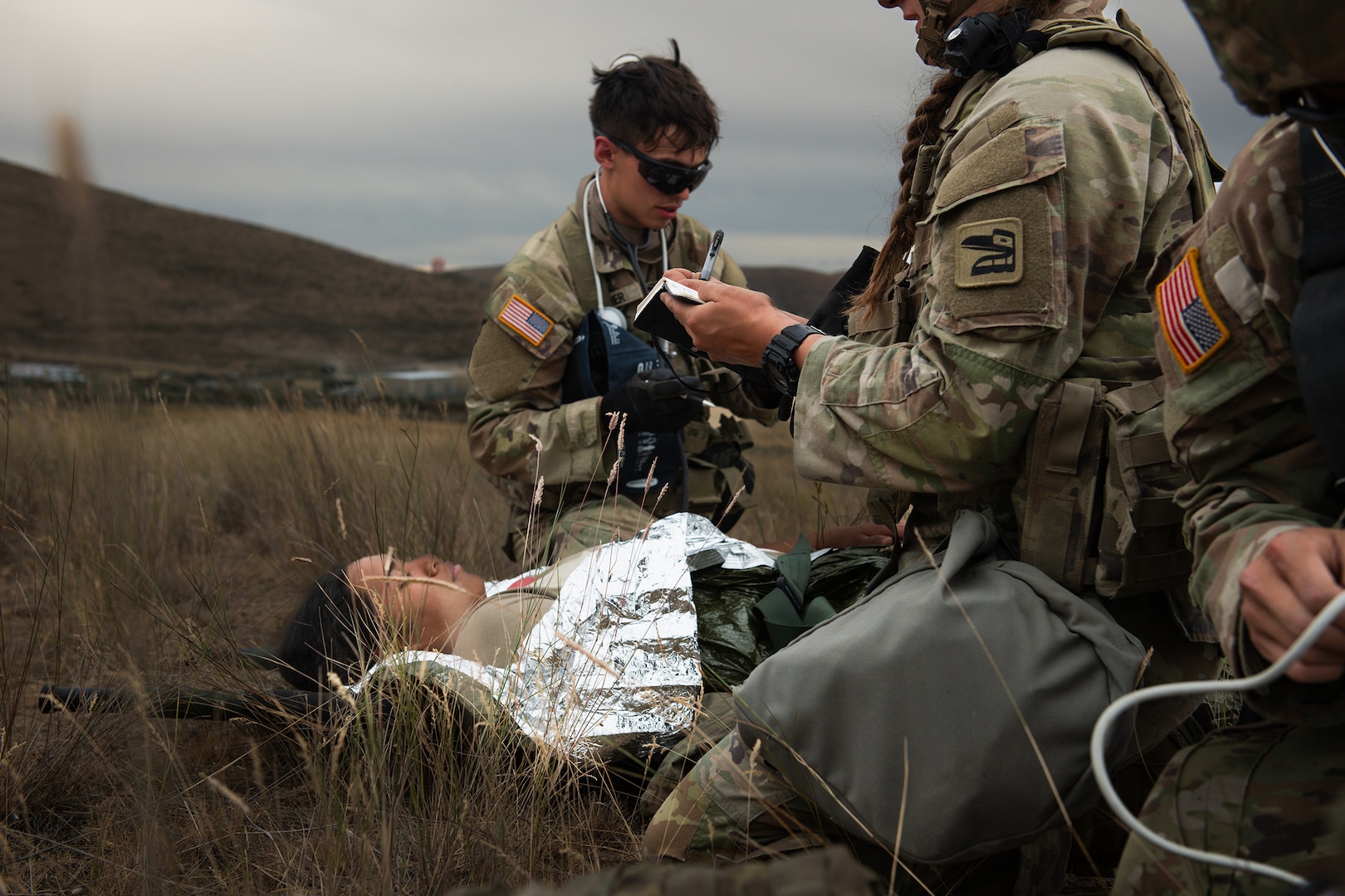 U.S. Army Spc. Julian Warner with Charlie Company, 181st Brigade Support Battalion, 81st Stryker Brigade Combat Team, Washington National Guard, administers aid to a patient during mass casualty training at Yakima Training Center, Wash., July 20, 2025.