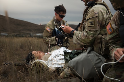 U.S. Army Spc. Julian Warner with Charlie Company, 181st Brigade Support Battalion, 81st Stryker Brigade Combat Team, Washington National Guard, administers aid to a patient during mass casualty training at Yakima Training Center, Wash., July 20, 2025.