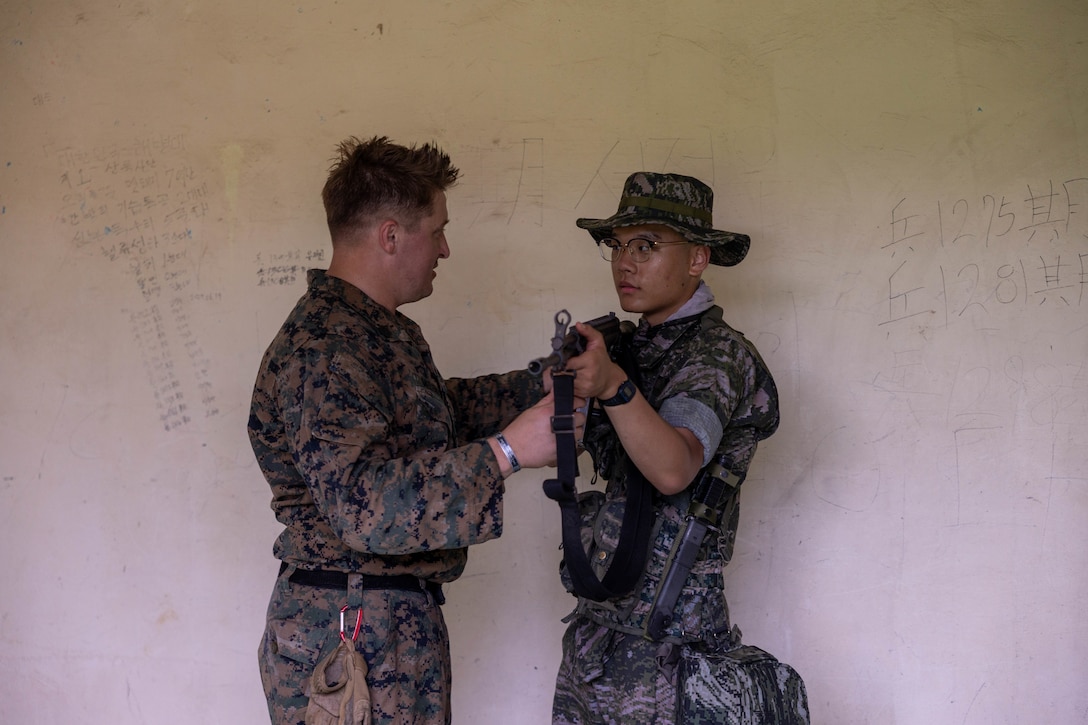 U.S. Marine Corps Staff Sgt. Michael Melendez, a rifleman with Golf Company, 2nd Battalion, 23rd Marines, forward deployed with 4th Marine Regiment, 3rd Marine Division as part of the Unit Deployment Program, teaches room clearing techniques to a Republic of Korea Marine during the Korean Marine Exercise Program, July 21, 2025. KMEP is conducted regularly between the ROK and U.S. Marine Corps to increase their combined capabilities through realistic training geared towards deterring threats and maintaining peace in the Indo-Pacific. Melendez is a native of Tennessee. (U.S. Marine Corps photo by Cpl. Kanoa Thomas)